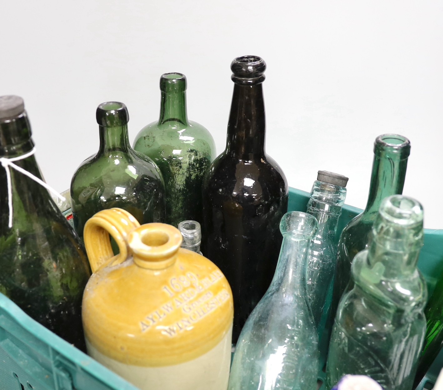 A Hardens 'Hand Grenade' fire extinguisher, an 18th century apothecary's bottle and various small coloured glass potion and ink bottles together with a collection of old wine and mineral water bottles